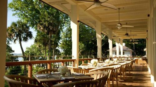 a row of tables and chairs on a porch at Signature 5 Bedroom Lagoon Residence 1003 in Bluffton