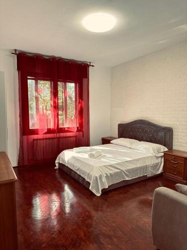 a bedroom with a bed and a red window at Venice Cappucina Guest House in Mestre