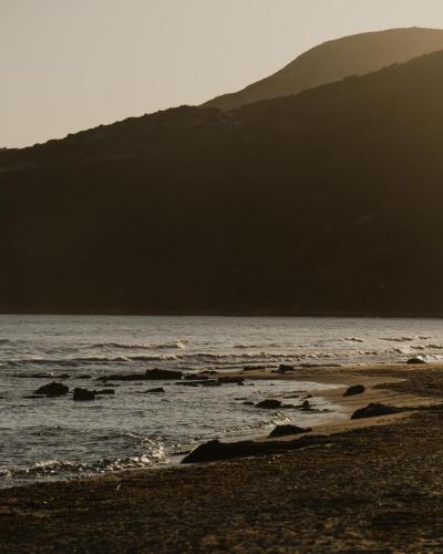 a beach with a mountain in the background at Sundara Estate, Exclusive Seaview Villa with Grand Pool & Direct Beach Access in Ratzaklíon