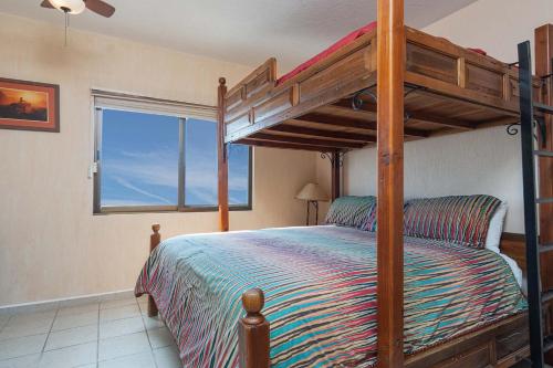 a bedroom with a bunk bed and a window at Wait 'n Sea Retreat Spacious Oceanfront Condo in Puerto Peñasco