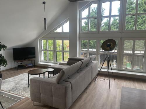 a living room with a couch and a tv at Hengstresort Velten in Velten