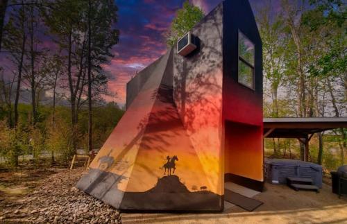 a mural painted on the side of a building at TeePee at Paradise Point with a hot tub fire pit & grill in Bryant