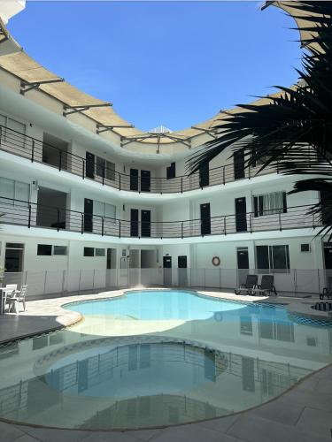 a large swimming pool in the middle of a building at Hotel El Potrillo in Puerto López