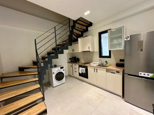 a kitchen with a staircase and a washing machine at Nuovo Maistros Villas in Tsoukaladhes
