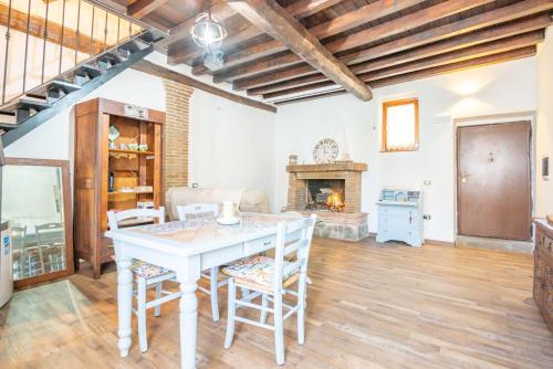 a living room with a table and a fireplace at La Casa di Fabiola in Bracciano