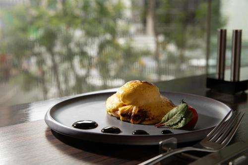 a plate with a piece of food on a table at ANA Crowne Plaza Fukuoka by IHG in Fukuoka