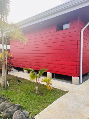 a red wall on the side of a building at Serenity Gardens Villa con Jacuzi in Fortuna