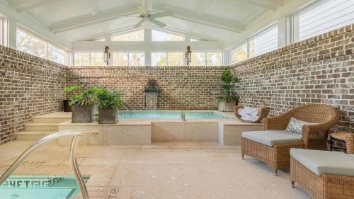 a large room with a hot tub in a brick wall at Lagoon View 2 Bedroom Wilson Village Home 5037 in Bluffton