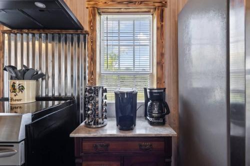 a kitchen with a counter and a refrigerator and a window at The Prairie House Retreat in Mentone