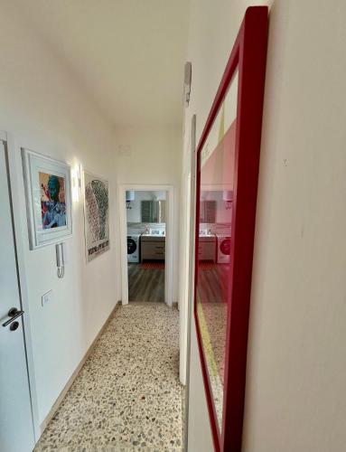 a hallway with a red door and a mirror at Alloggio Primavera Matilde in Terni