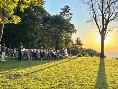a crowd of people sitting in chairs in a park at Cragsmere Manor - Luxury Estate & Event Space in Mentone