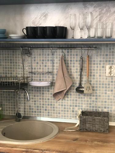 a kitchen counter with a sink with glasses and utensils at Lucky Space 1 Nice&Cosy Studio in Budva