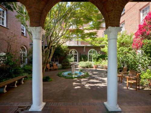 a courtyard with two white columns and a fountain at SF Zen Center Guestrooms in San Francisco