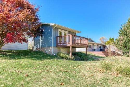 a house with a deck on a yard at New River 3BR - Fishing, Hot Tub and VT Game Weekends in Radford