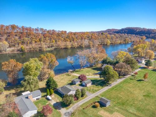 an aerial view of a home with a lake at New River 3BR - Fishing, Hot Tub and VT Game Weekends in Radford