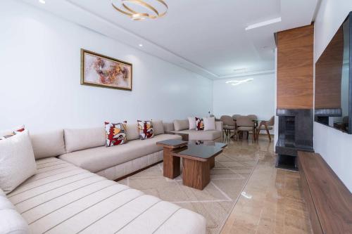 a living room with a couch and a fireplace at Appartement avec Piscine dans Résidence Privée in Dar Bouazza