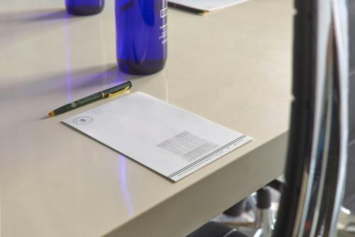 a pen sitting on top of a table with a notebook at The Tremont House, Galveston, a Tribute Portfolio Hotel in Galveston
