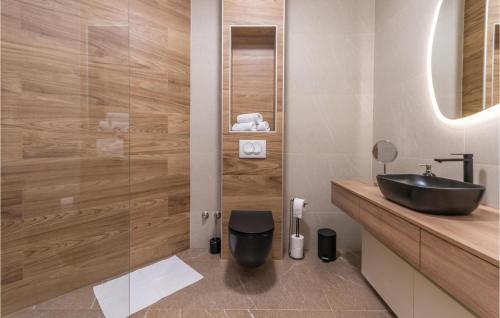 a bathroom with a black sink and a mirror at Amazing Home In Kakma With Sauna in Kakma