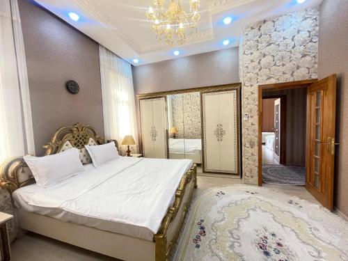 a bedroom with a large bed with a chandelier at Museum Boutique Luxury GH in Sheki