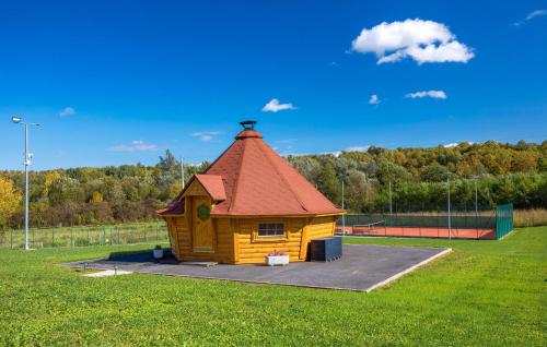 a small wooden cabin with a red roof in a park at Amazing Home In Petrinja With Wi-Fi in Petrinja