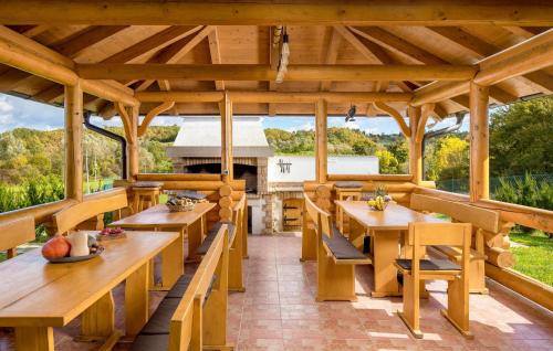 a large wooden pavilion with wooden tables and chairs at Amazing Home In Petrinja With Wi-Fi in Petrinja