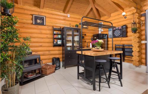 a kitchen with a stove and a table in a room at Amazing Home In Petrinja With Wi-Fi in Petrinja