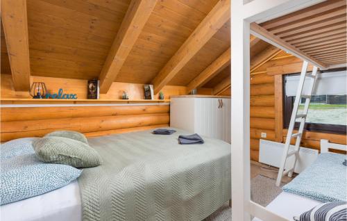 a bedroom with a bed in a wooden cabin at Amazing Home In Petrinja With Wi-Fi in Petrinja
