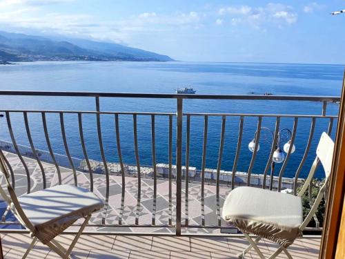 a balcony with two chairs and a view of the water at Il MOLO Camere per vacanze in Diamante