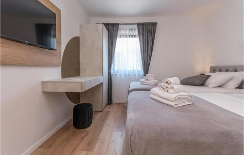 a hotel room with a bed and a sink and a tv at Amazing Home In Kakma With Sauna in Kakma