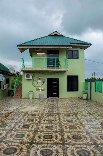 a building with a tile floor in front of it at Luxurious Akwaaba Apartments in Takoradi