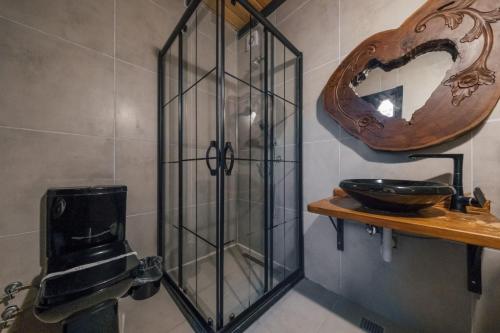 a glass shower in a bathroom with a toilet at MC Sapanca Hotel in Sakarya
