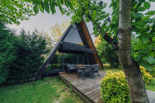 a cabin with a table and chairs on a wooden deck at MC Sapanca Hotel in Sakarya