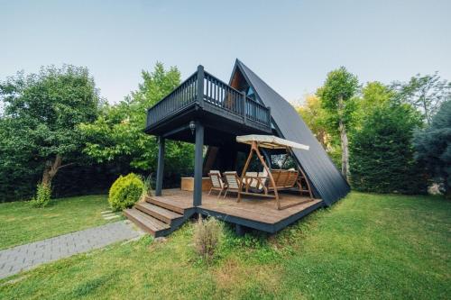 a tiny house with a deck and a porch at MC Sapanca Hotel in Sakarya