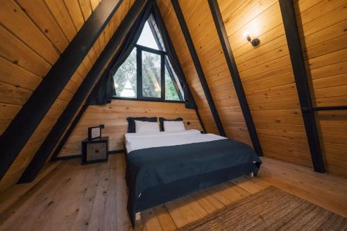 a bedroom with a bed in a wooden cabin at MC Sapanca Hotel in Sakarya