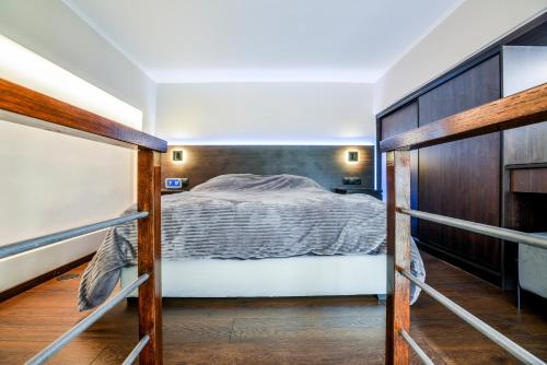 a bedroom with a bed and a wooden wall at The Lynx Konitsa in Konitsa