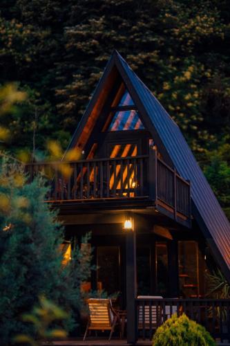 a log cabin with a balcony and a deck at MC Sapanca Hotel in Sakarya