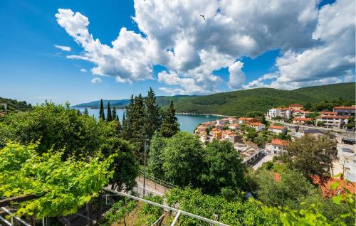 a view of a town and a body of water at 1 Bedroom Beautiful Apartment In Rabac in Rabac