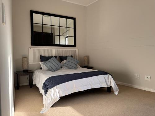 a bedroom with a bed with a window above it at Beachview Apartment in Hout Bay