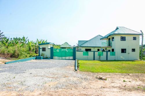 a house with a fence in front of it at Luxurious Akwaaba Apartments in Takoradi