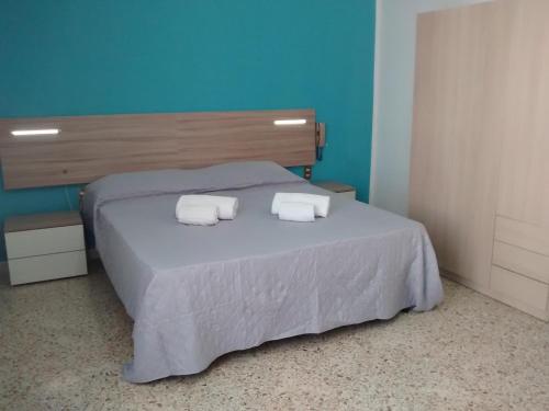 a bedroom with a bed with two towels on it at Carpe Diem Apartments in Castellammare del Golfo