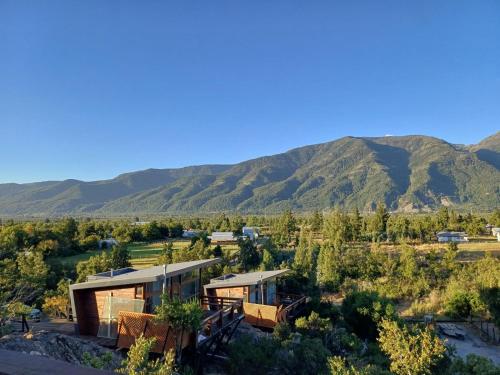 an aerial view of a house with mountains in the background at Senderos in Antuco