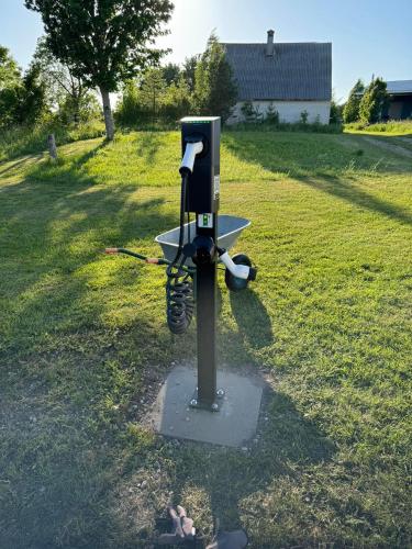 a pay phone in the middle of a field at Ungru Guesthouse in Suuresadama