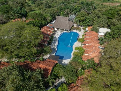 an overhead view of a house with a swimming pool at Seis Playas Hotel in Tamarindo