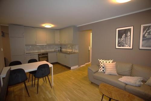a living room with a couch and a table at Modern Grünerløkka gem in Oslo
