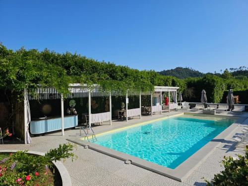 a swimming pool in a garden with trees at Casa Rea in Beverino