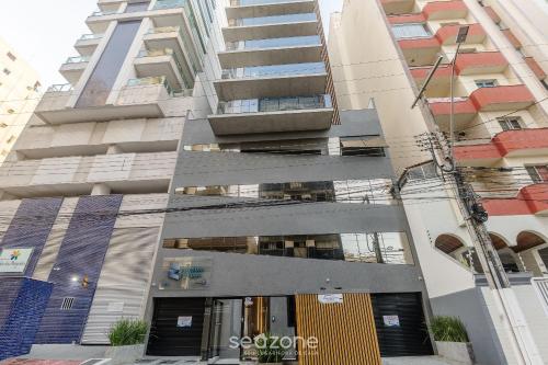 an external view of the facade of a building at Prédio c/ Aptos Novos a 300m da Praia - EEP in Guarapari
