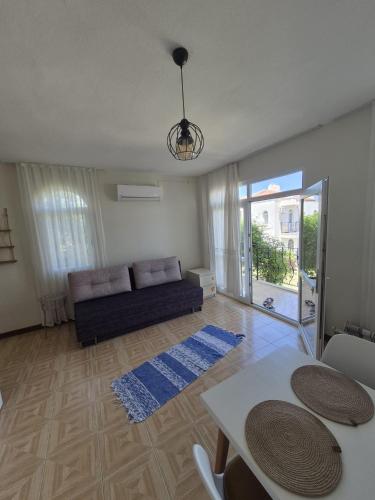 a living room with a couch and a table at Datcha Cozyhomes1 in Datca