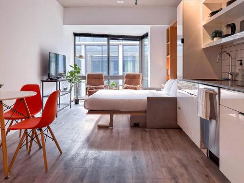 a bedroom with a bed and a table and chairs at City & River View Suite - The Wharf DC by Monthier in Washington, D.C.