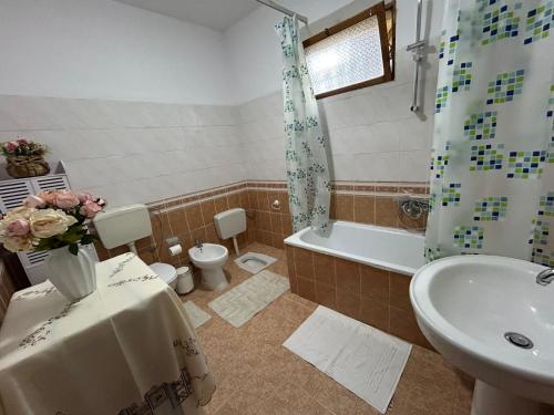 un bagno con lavandino, WC e doccia di Top Guesthouse a Shkodër