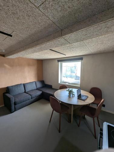 a living room with a couch and a table with a laptop at Lofoten Apartment 02 in Leknes